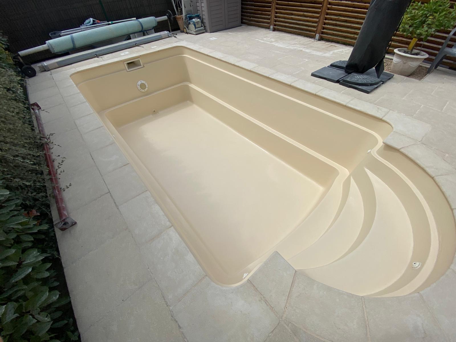 Cream polyester pool — overhead view showing sculpted steps
