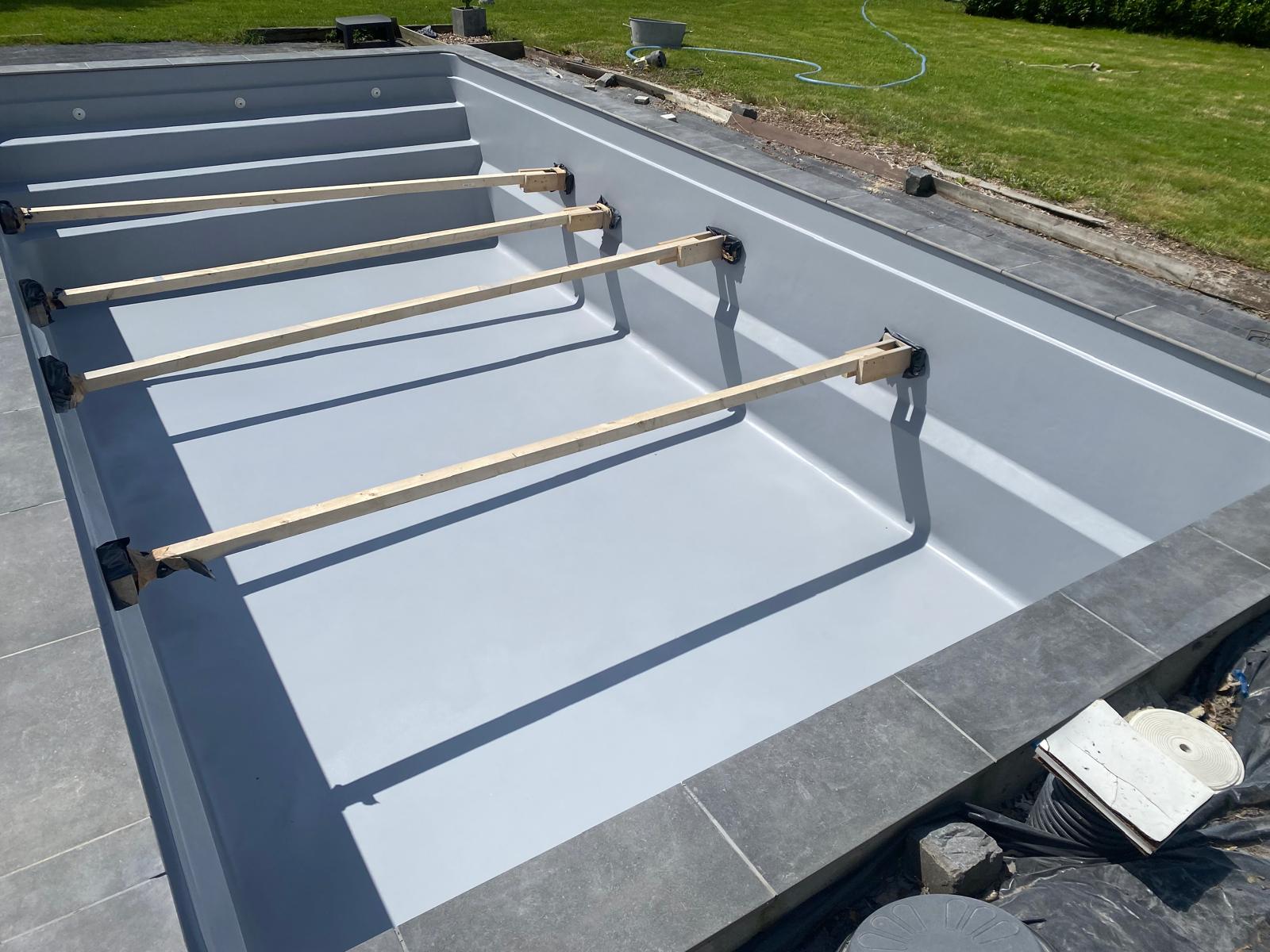 Light grey polyester pool under construction in Belgium